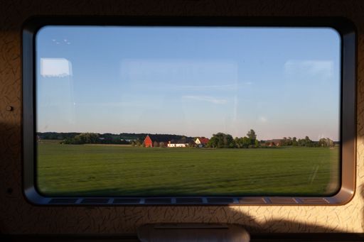 A daytime view from a van window of a typical farm with farmhouses nearby Helsingborg, Sweden