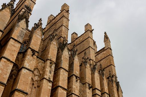 A low-angle shot of part of Palma Cathedral built in gothic style under the cloudy sky