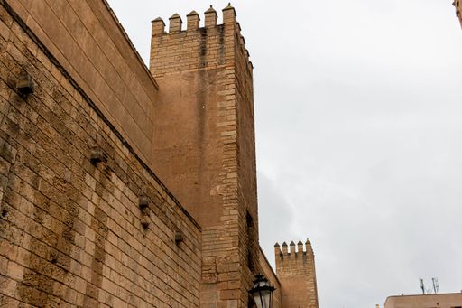 A low angle shot of the facade of the gothic style Palm Cathedral under the clouds