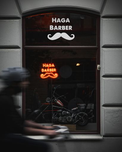 A rider drives by Haga Barber in Gothenburg, Sweden