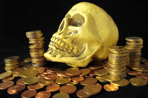 Death and Money Concept Skull and Currency over a Black Background