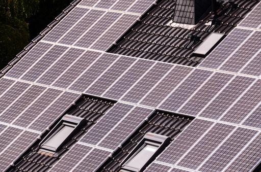 Green Renewable Energy with Photovoltaic Panels on the Roof.