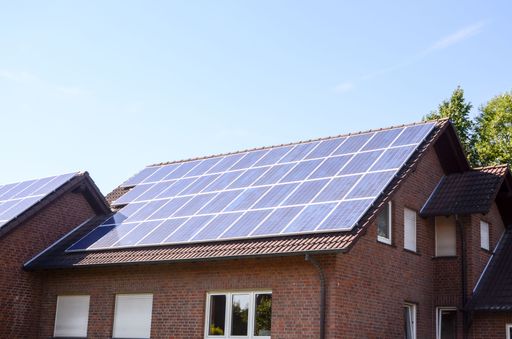 Green Renewable Energy with Photovoltaic Panels on the Roof.
