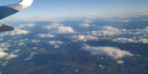 A beautiful shot of a sky above clouds seen from an airplane window