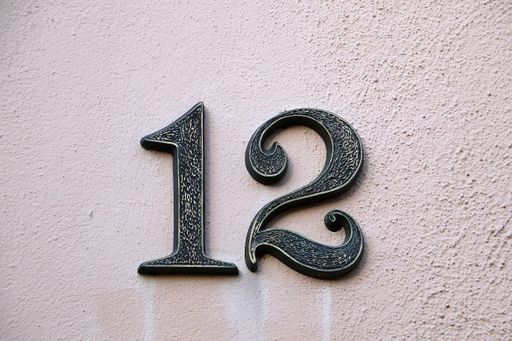 A closeup shot of number 12 on a concrete wall