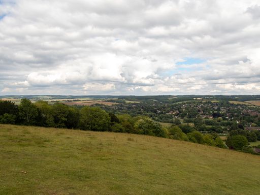 A view of the a town from a hill under cloudy skies