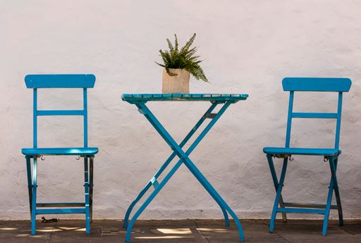 A close up shot of chairs and a table in a minimalist cafe