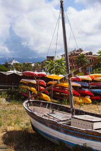 A vertical shot of a fishing boat in a field