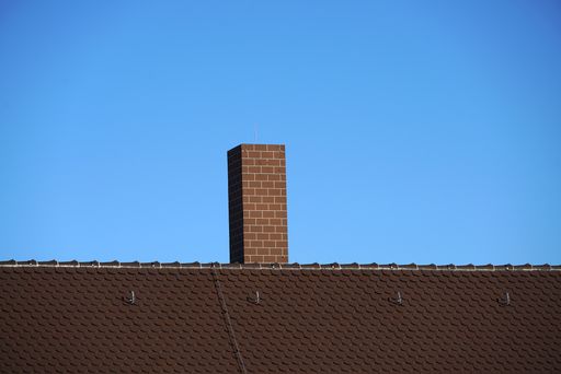 A view of an old brick chimney on a roof