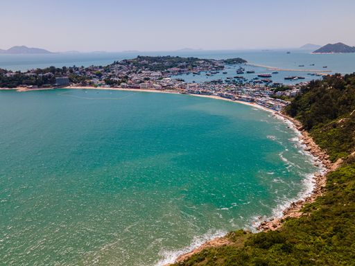 An aerial view of the forested coast and sea in Cheung Chau, Hong Kong