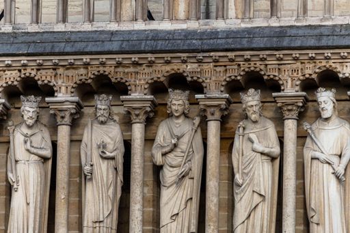 A closeup of four ornate statues situated on the front of a building