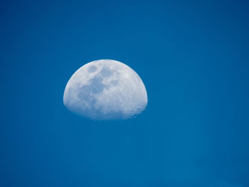 The waxing gibbous phase of the moon on a blue sky at daytime