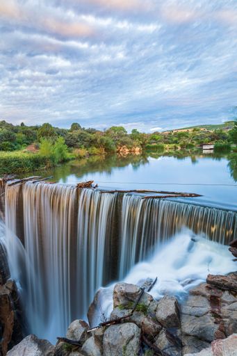 A breathtaking view of a waterfall over Fain Dam at Fain Park in Prescott Valley, Arizona
