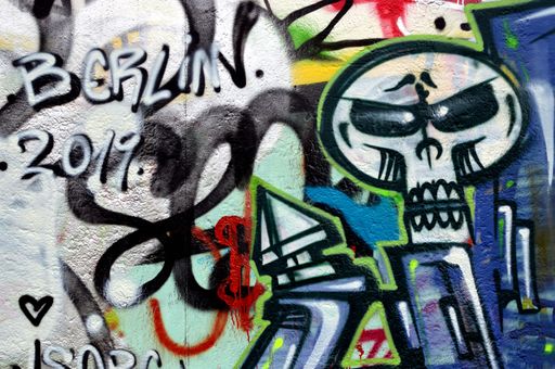 A Berlin 2019 spray painted tag line with a skull on the right portion of the image