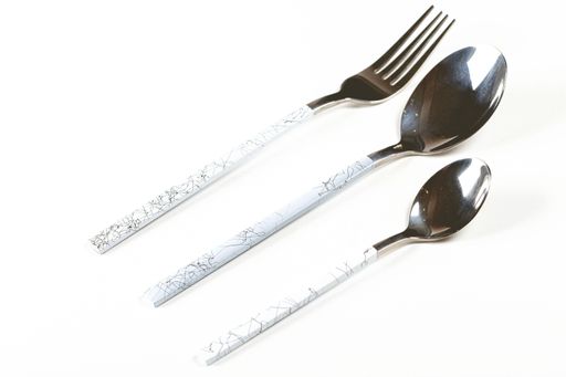 An arranged set of silver fork and two spoons on a white background