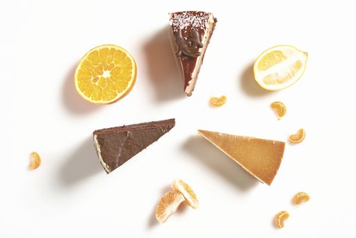 Three cake slices on a white background with citrus fruit
