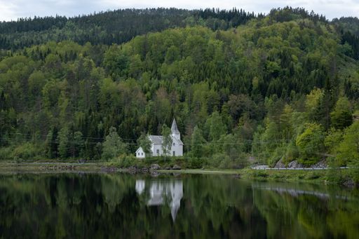 Wonderful landscapes in Norway. Vest-Agder. Mountains, road and trees in the background. Wooden floating platform.