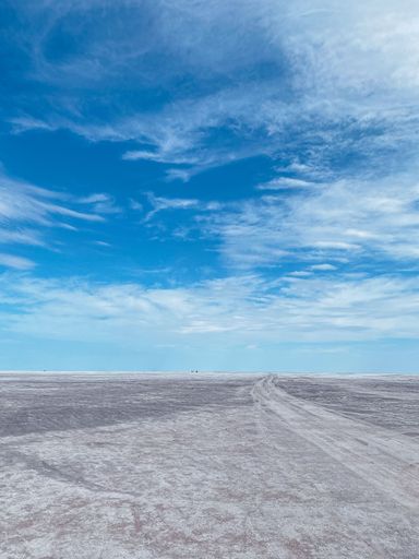 A scenic view of bright blue sky over a flat dry valley