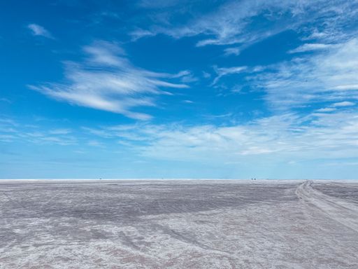A scenic view of bright blue sky over a flat dry valley