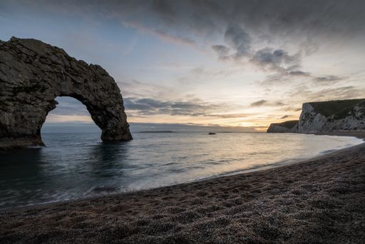 A breathtaking shot of the seashore of the Durdle Door in Lulworth, Dorset during sunset