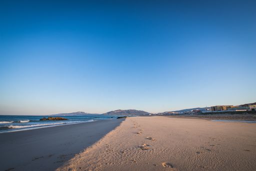A beautiful shot of the seashore in Tarifa in Spain with human traces on the sand