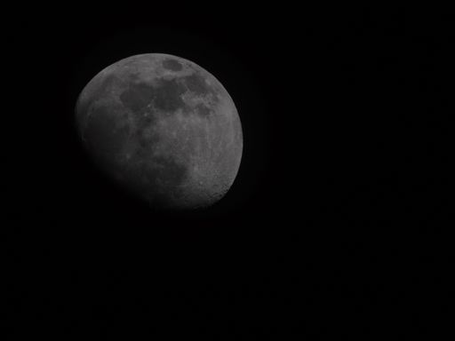 A closeup of the half moon shining in a dark night sky