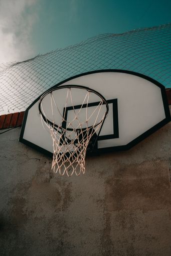 A vertical low angle shot of basketball hoop