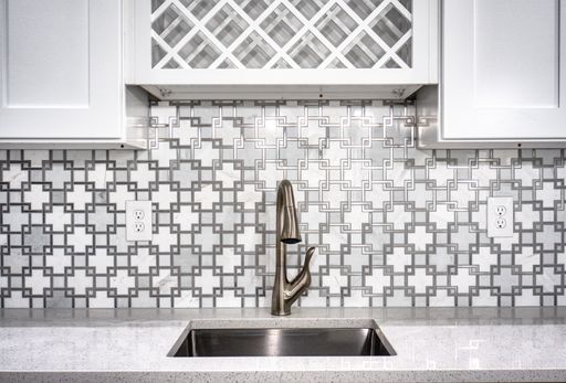 The interior of a modern kitchen with a golden faucet