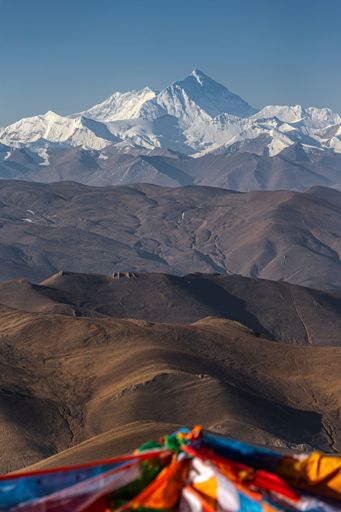An aerial view snow covered Everest mountain landscape with flags