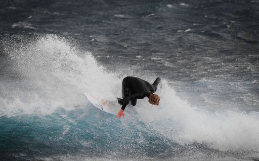 The view of a surfer falling into the waves of a sea