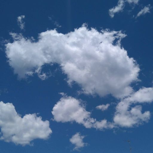 A low angle shot of a blue cloudy sky at daytime - great for wallpapers
