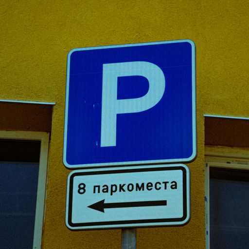 A closeup shot of the blue street sign showing that are 8 parking spots