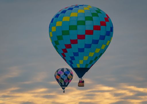 A blue air balloon in the sky during sunset