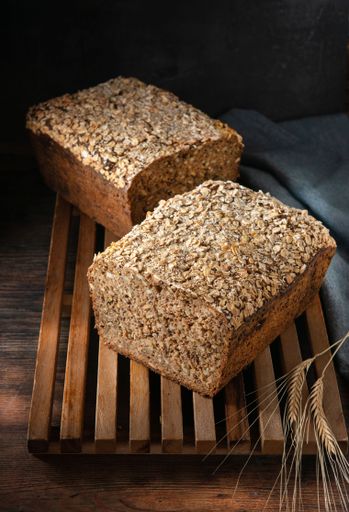 A vertical shot of cereal bread placed on a wooden surface