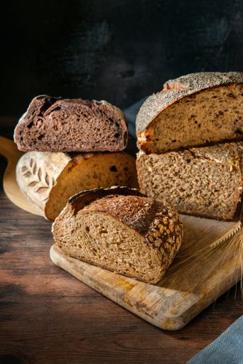 A vertical shot of sourdough bread placed on a wooden surface