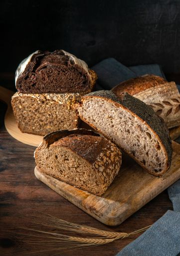 A vertical shot of sourdough bread placed on a wooden surface