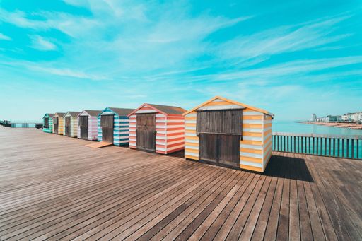 A beautiful scenery shot of colorful wooden houses on a deck by the beach