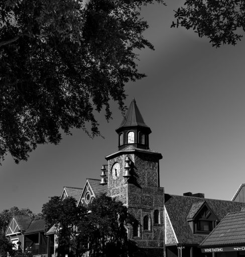 A grayscale shot of an old mill clock tower in Solvang, California