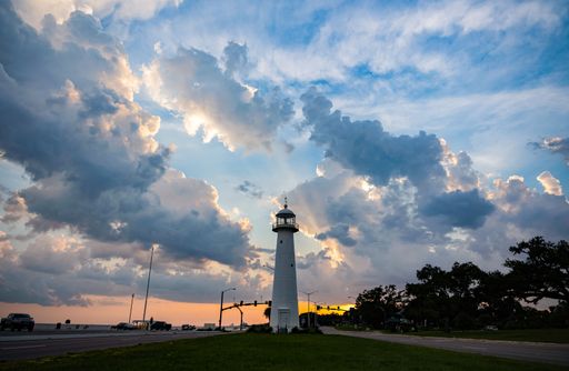 A landscape of Biloxi Lighthouse under the cloudy sky at sunset in Biloxi, Mississippi