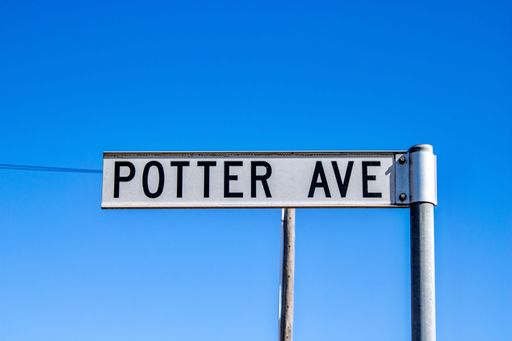 A closeup shot of a Potter Avenue street sign against a blue sky background at Emmaville, Australia