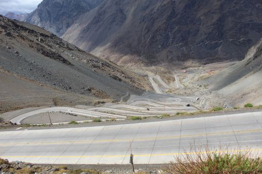 A high angle shot of an empty road in the rocky mountains