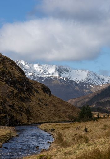 A river in a mountainous area on a cloudy day
