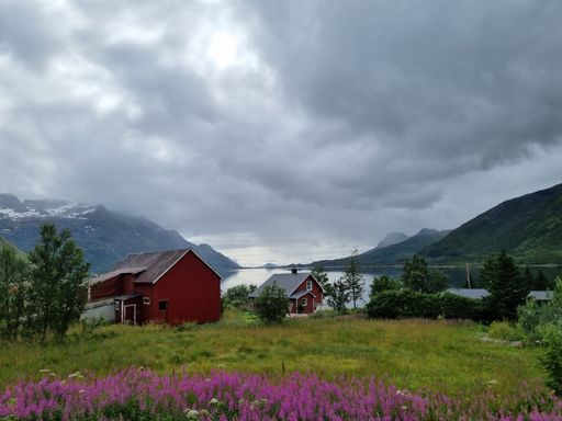The cloudy sky over the rocky landscapes and a lake in Norway