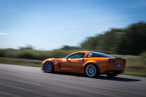 An orange race car chevrolet at the track
