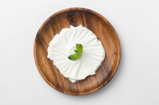 A top view of Yogurt in a wooden plate