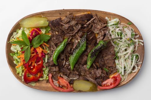 A top view of the meat doner in a wooden plate