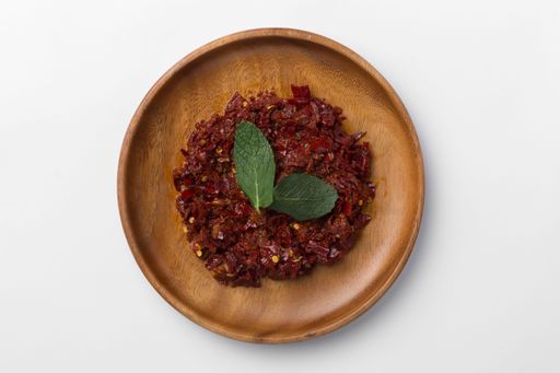 A top view of a spicy paste in a wooden table