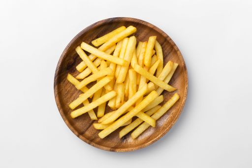 A top view of the French fries in a wooden plate isolated on white background