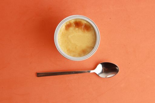 An overhead shot of delicious egg flan in aluminum container