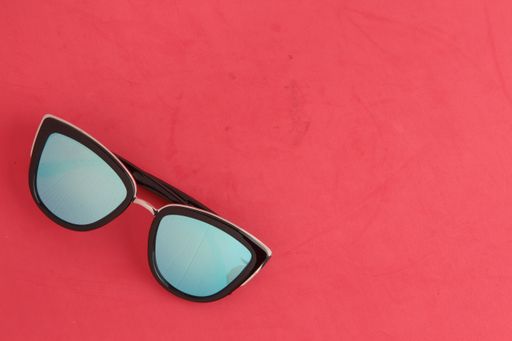 A top view of the sunglasses on the red surface